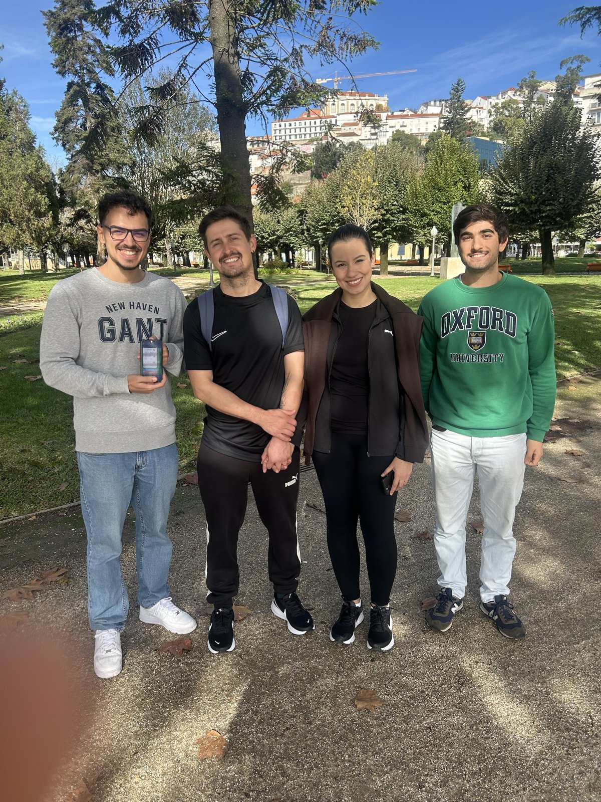 The GreenTrack team in Coimbra, showing the app on a phone